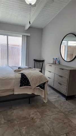 a bedroom with a bed and a mirror