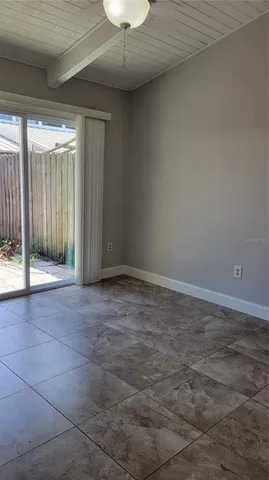 a view of an empty room with glass door