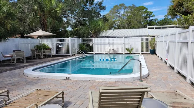 an aerial view of a house with swimming pool and furniture