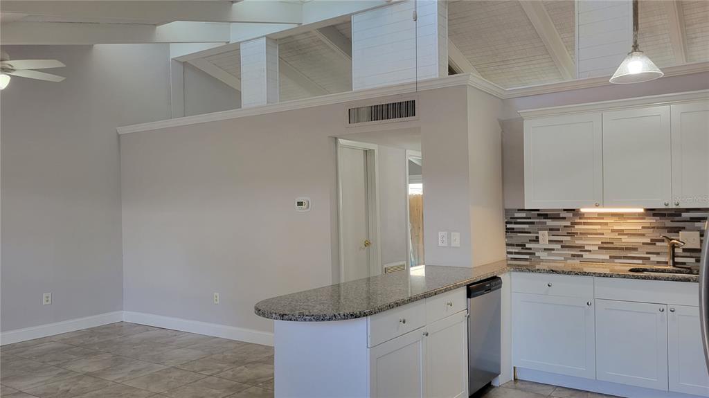500 North Jefferson Avenue, Unit E5 Sarasota, FL 34237 - Photo 8 of 22 a bathroom with a granite countertop sink and a mirror
