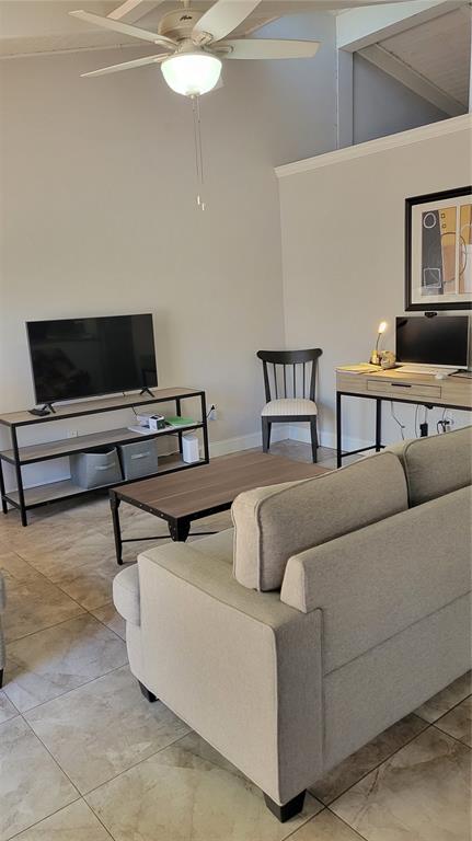 500 North Jefferson Avenue, Unit E5 Sarasota, FL 34237 - Photo 9 of 22 a living room with furniture and a flat screen tv