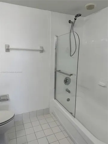 a bathroom with a shower and a toilet