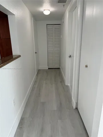a view of hallway with furniture and a large window