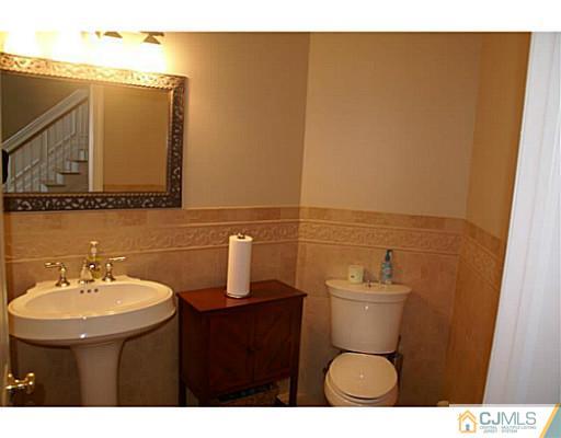 16 Westley Road Old Bridge, NJ 08857 - Photo 15 of 25 a bathroom with a sink mirror and toilet