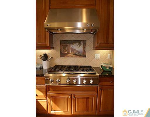 16 Westley Road Old Bridge, NJ 08857 - Photo 21 of 25 a stove top oven sitting inside of a kitchen