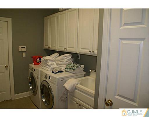 16 Westley Road Old Bridge, NJ 08857 - Photo 22 of 25 a utility room with dryer and washer