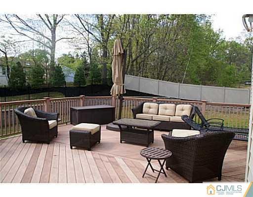 16 Westley Road Old Bridge, NJ 08857 - Photo 24 of 25 a balcony with wooden floor table and chairs