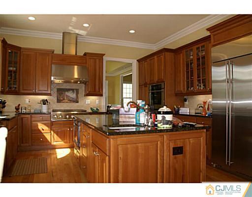 16 Westley Road Old Bridge, NJ 08857 - Photo 4 of 25 a kitchen with kitchen island granite countertop a refrigerator stove top oven and sink