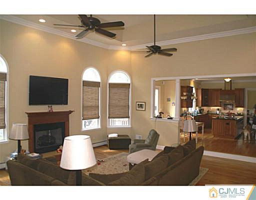 16 Westley Road Old Bridge, NJ 08857 - Photo 6 of 25 a living room with fireplace furniture and a flat screen tv