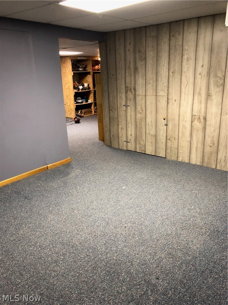 4864 Phillips Rice Road Cortland, OH 44410 - Photo 32 of 35 Another basement space that includes a bar. The carpet softens the floor area.