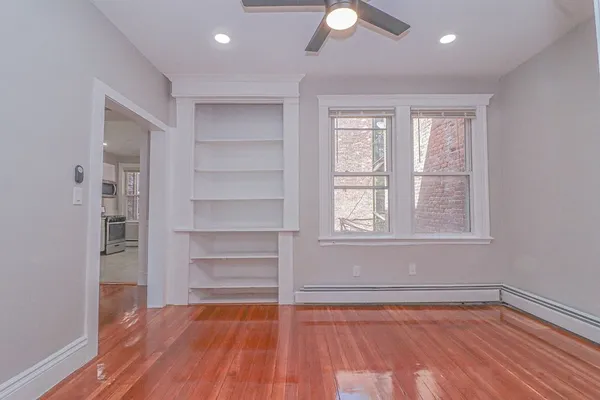 a view of a room with wooden floor and window
