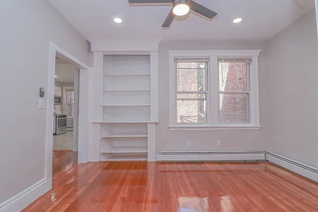 a view of a room with wooden floor and window