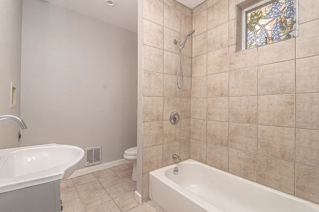 a bathroom with a bathtub and toilet