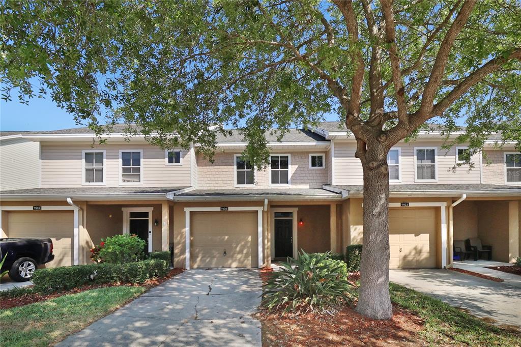a front view of a house with garden and porch