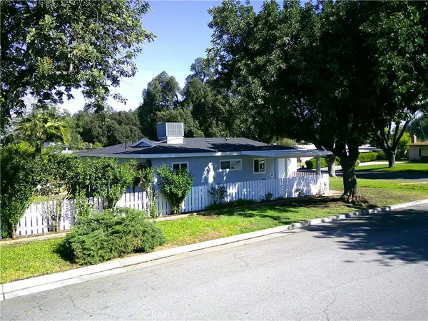 a front view of a house with a yard and a garage