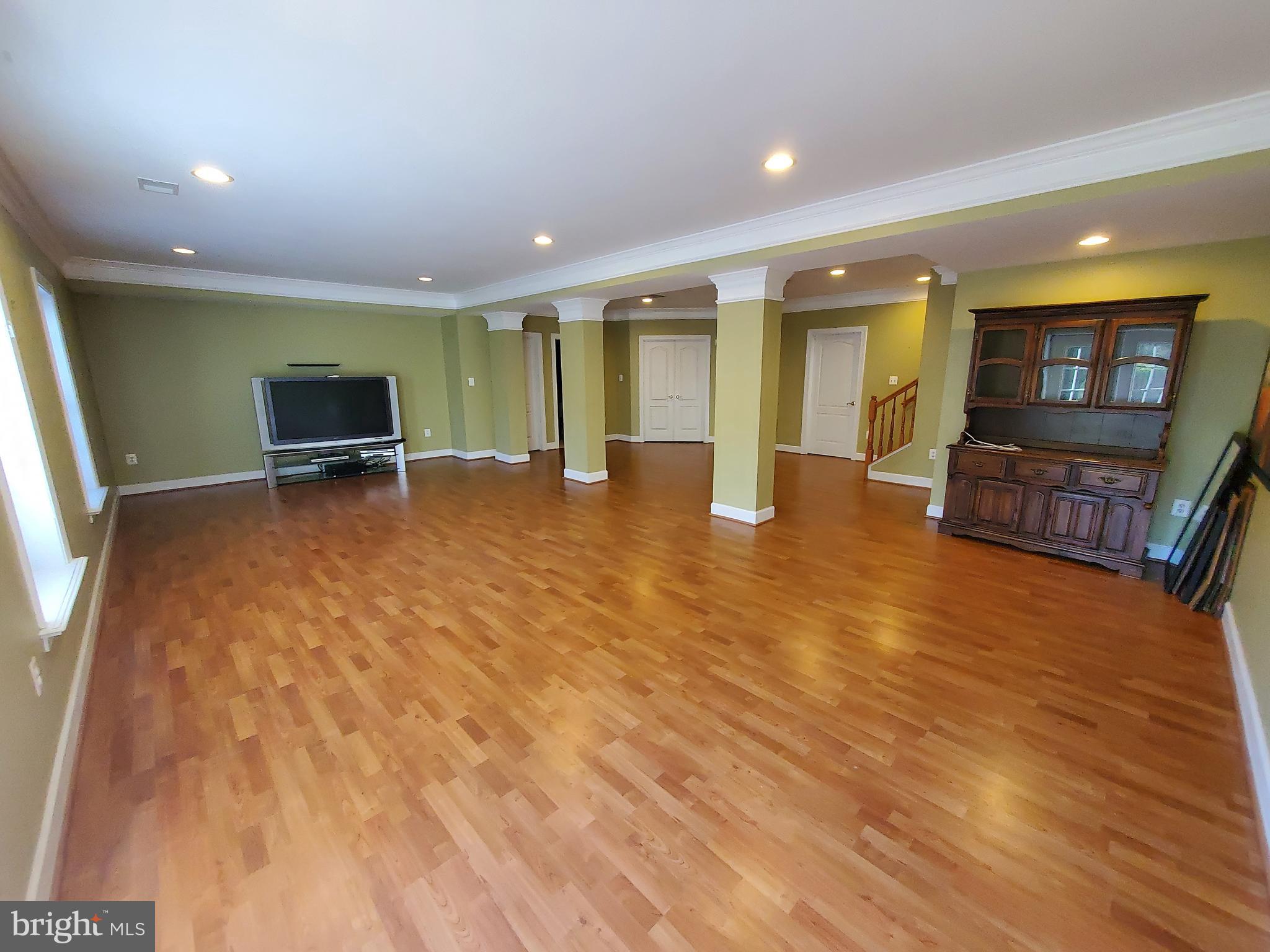 14418 Ashleigh Greene Road Boyds, MD 20841 - Photo 22 of 31 a view of a livingroom with furniture flat screen tv and staircase
