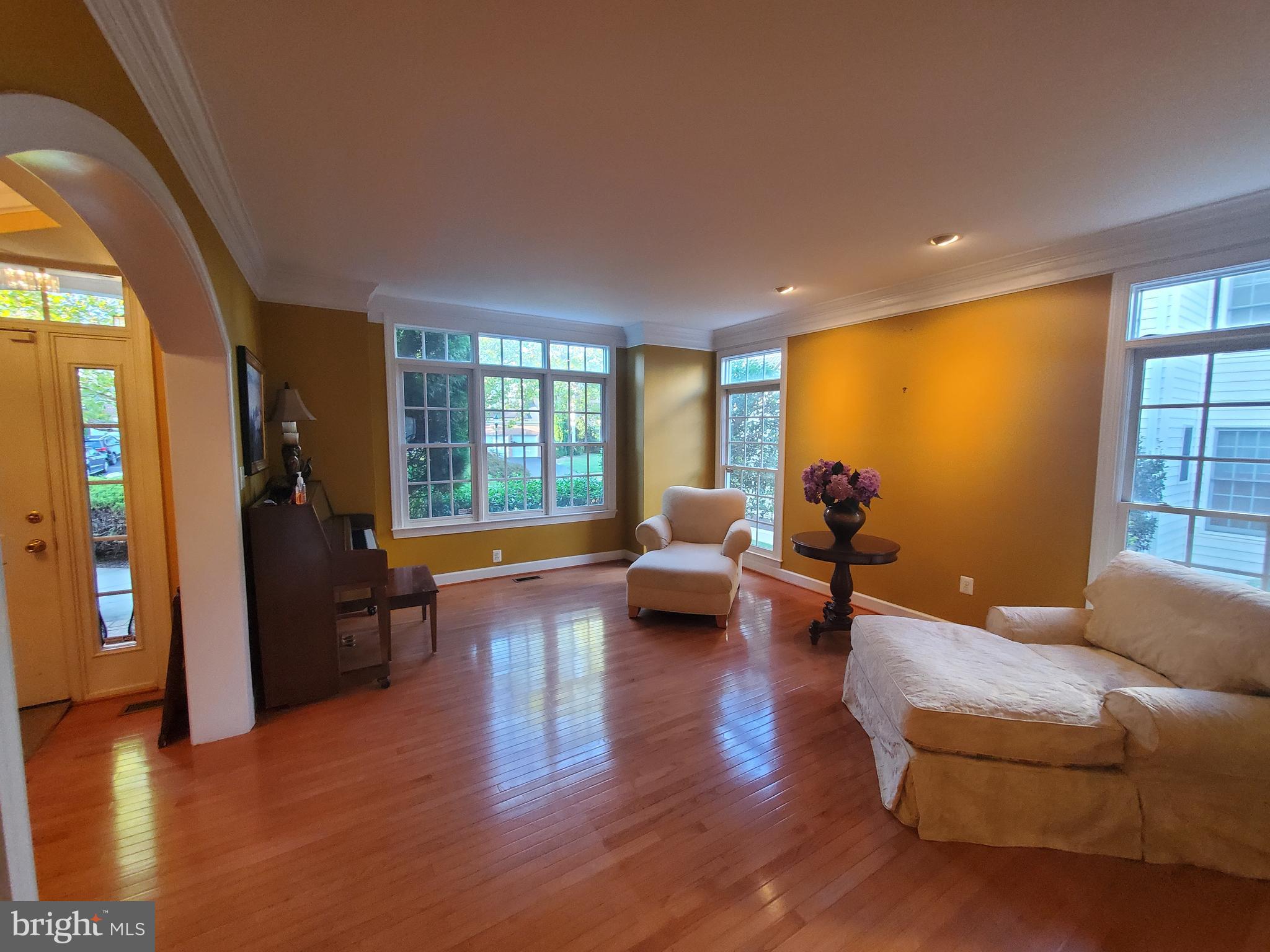 14418 Ashleigh Greene Road Boyds, MD 20841 - Photo 4 of 31 a living room with furniture floor to ceiling window and wooden floor