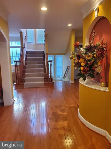 a living room with furniture floor to ceiling window and wooden floor