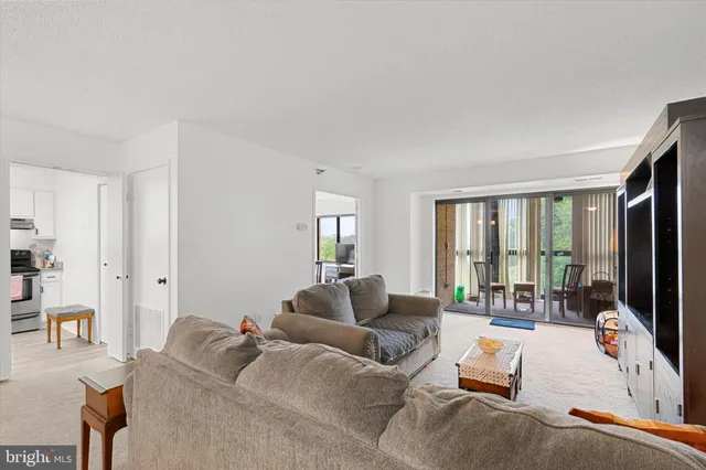 a living room with furniture large window and a flat screen tv