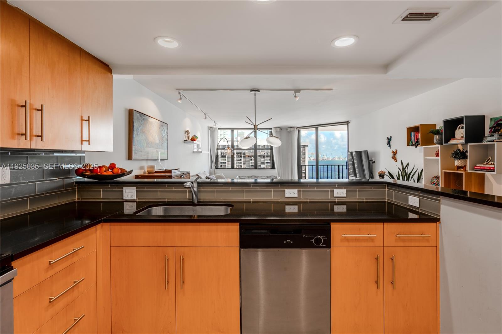 1925 Brickell Avenue, Unit D2006 Miami, FL 33129 - Photo 12 of 46 a kitchen with granite countertop a sink and cabinets