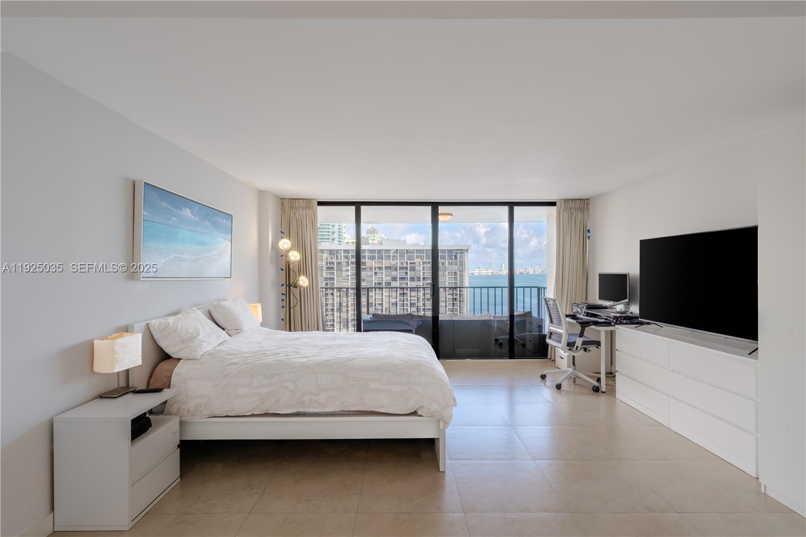 1925 Brickell Avenue, Unit D2006 Miami, FL 33129 - Photo 14 of 46 a bedroom with a bed and large window