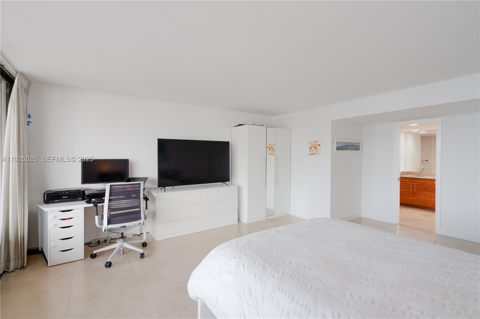 1925 Brickell Avenue, Unit D2006 Miami, FL 33129 - Photo 16 of 46 a bedroom with a bed and a flat screen tv