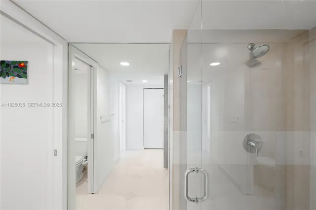 a bathroom with a shower and a glass door