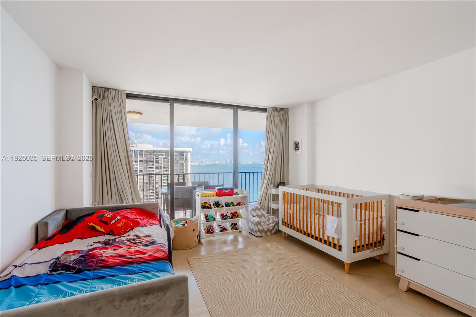 1925 Brickell Avenue, Unit D2006 Miami, FL 33129 - Photo 23 of 46 a living room with furniture and a large window