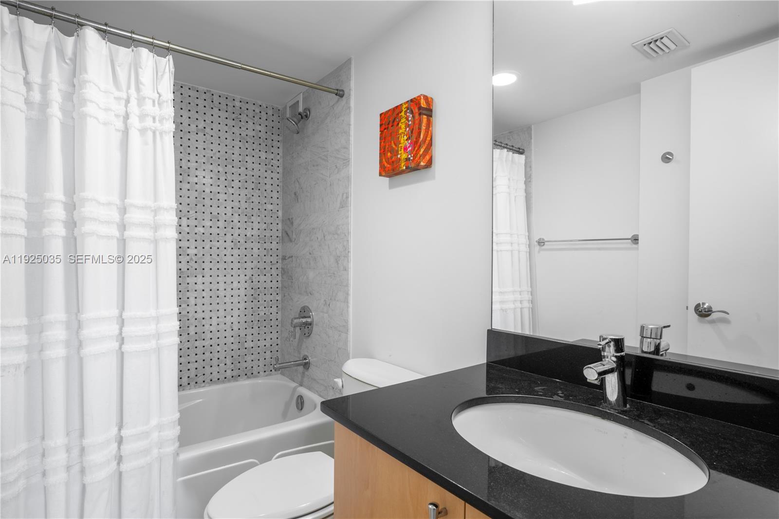 1925 Brickell Avenue, Unit D2006 Miami, FL 33129 - Photo 25 of 46 a bathroom with a sink and a mirror