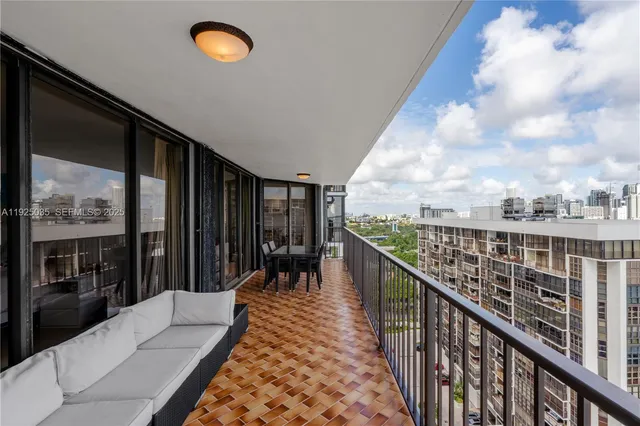a balcony with tall trees in front of it