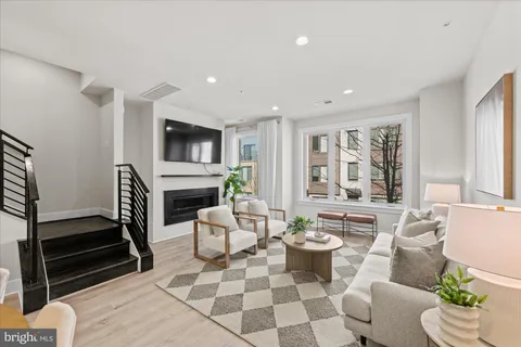 a living room with fireplace furniture and a flat screen tv