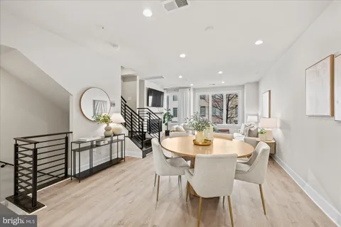 a view of a dining room with furniture and a chandelier