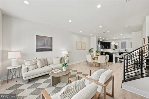 a living room with furniture and view of kitchen