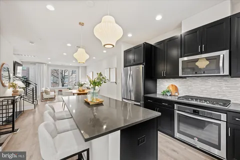 a kitchen with stainless steel appliances a stove microwave and cabinets