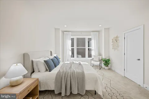 a bedroom with a bed and a window