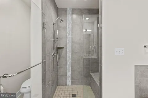 a bathroom with a shower and toilet