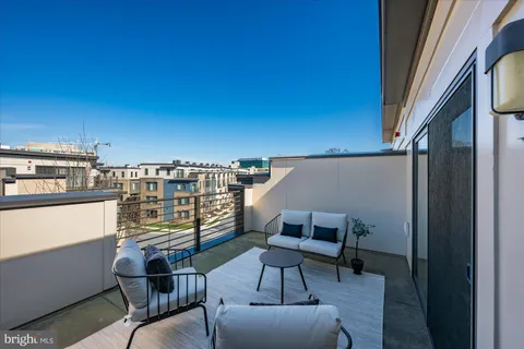 a view of a chairs and table in a balcony