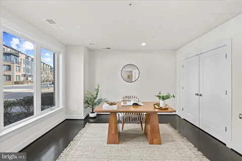 a dining room with wooden floor and a window