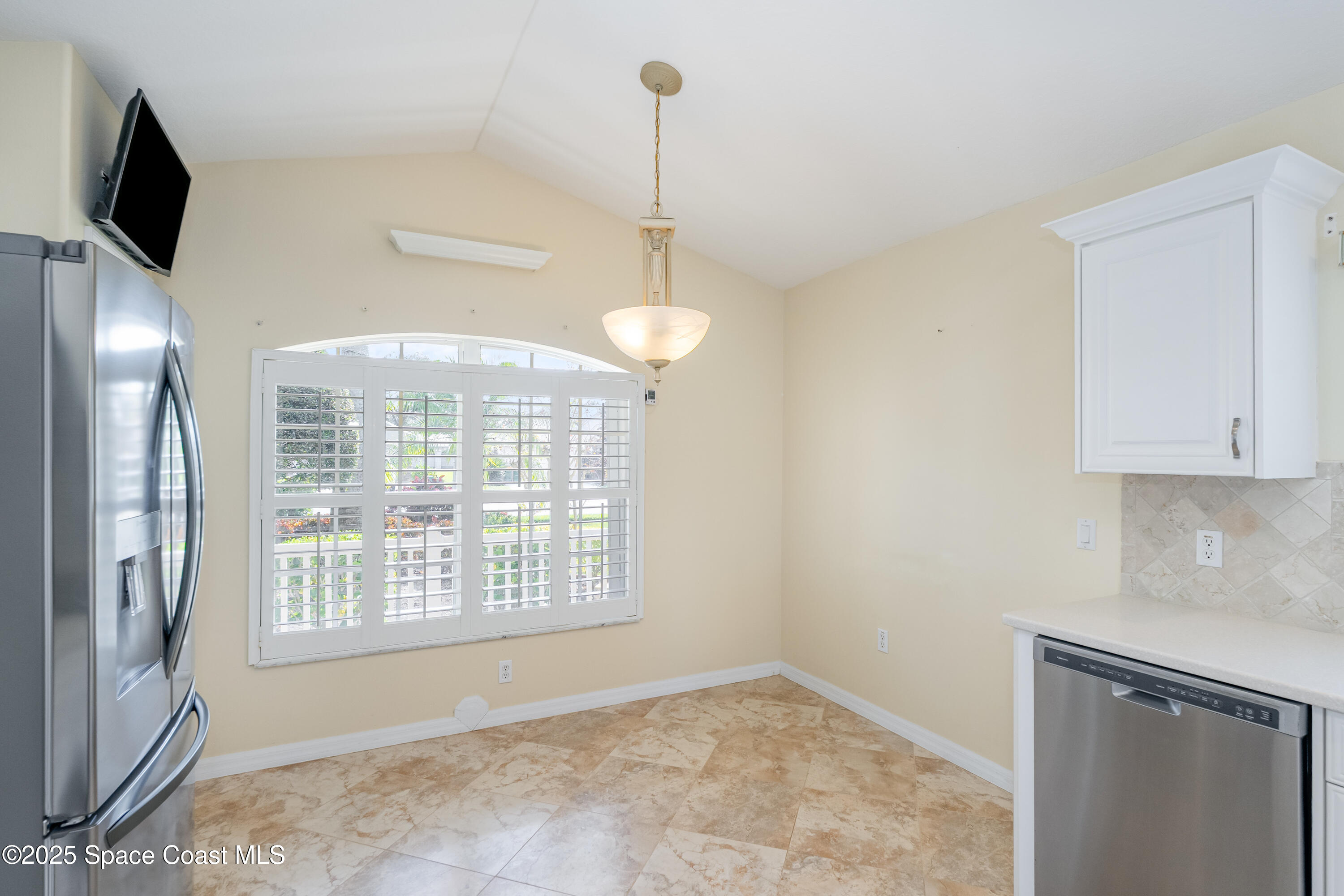 1664 Boca Rio Drive Melbourne, FL 32940 - Photo 13 of 46 a view of an empty room with window and cabinet area