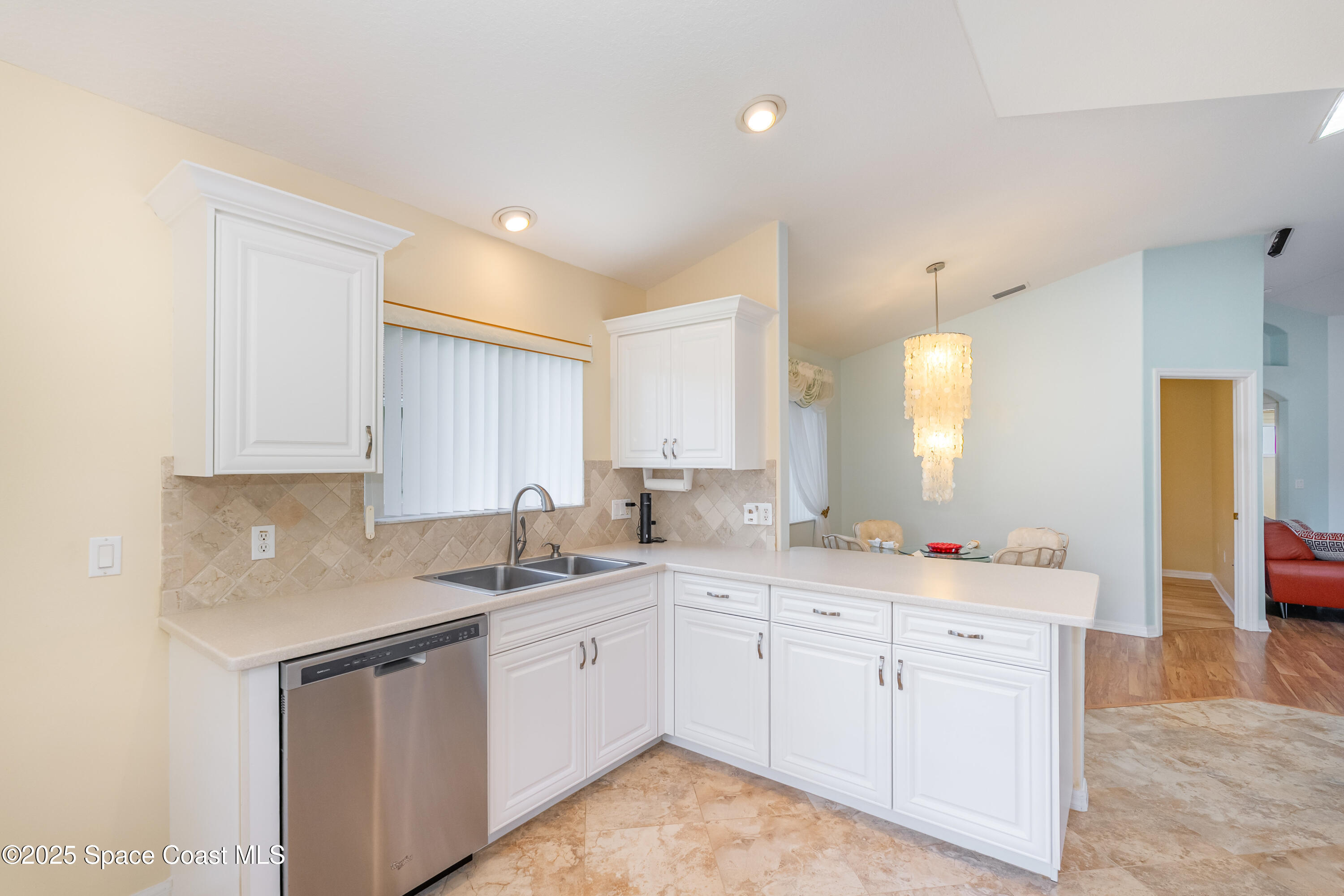 1664 Boca Rio Drive Melbourne, FL 32940 - Photo 14 of 46 a kitchen with a sink dishwasher window and cabinets