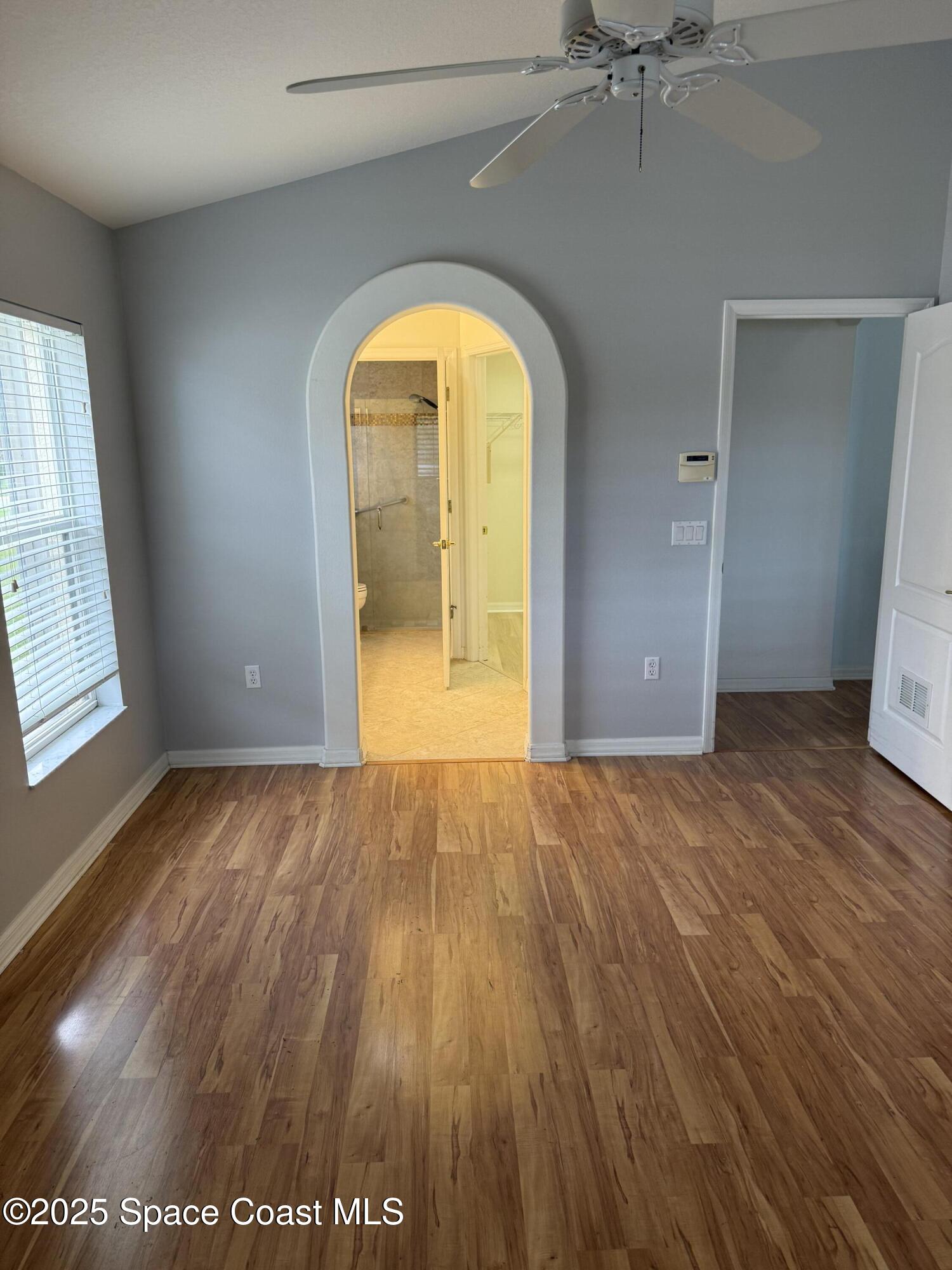 1664 Boca Rio Drive Melbourne, FL 32940 - Photo 16 of 46 an empty room with wooden floor and windows