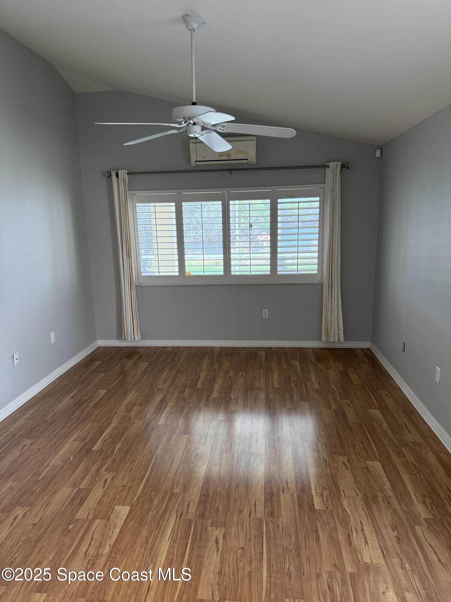 1664 Boca Rio Drive Melbourne, FL 32940 - Photo 17 of 46 an empty room with wooden floor and windows