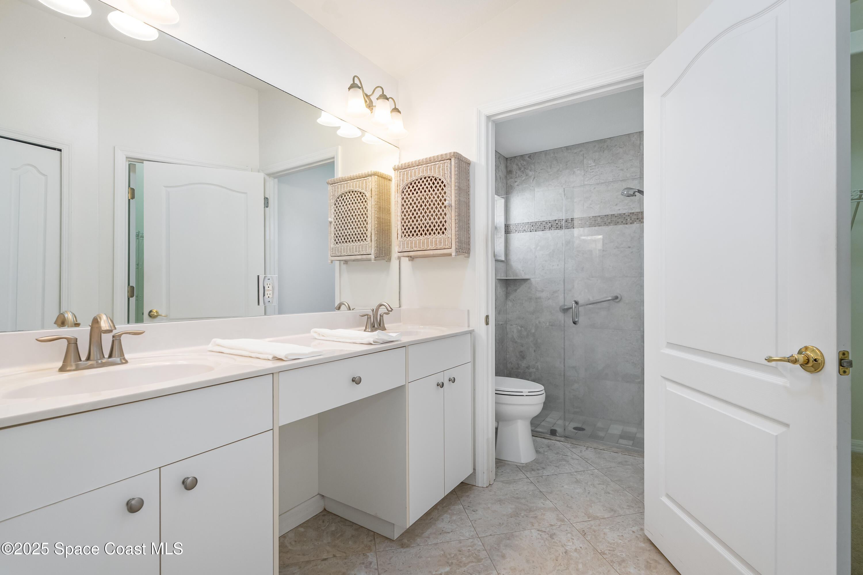 1664 Boca Rio Drive Melbourne, FL 32940 - Photo 18 of 46 a bathroom with a double vanity sink toilet and shower