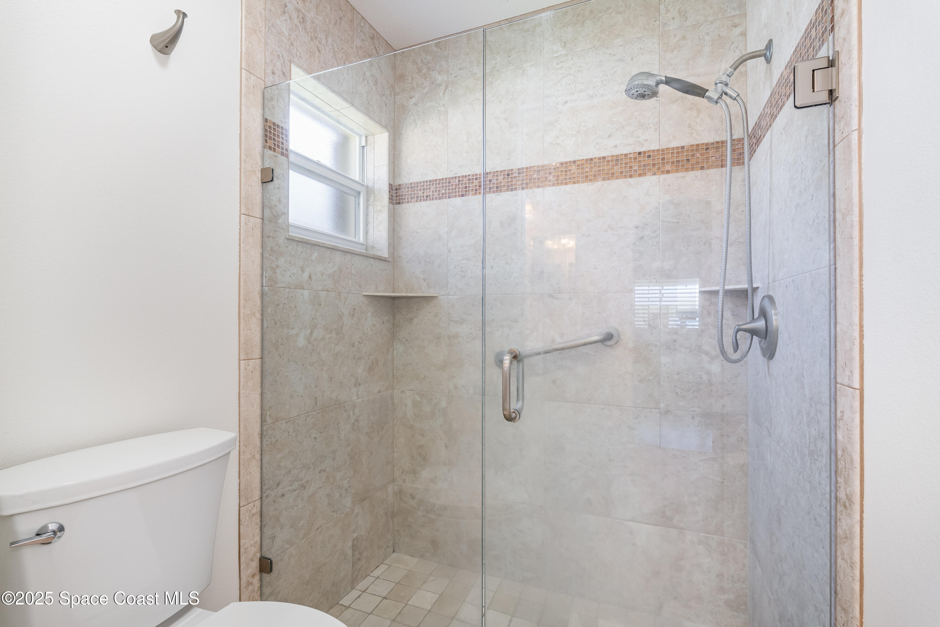 1664 Boca Rio Drive Melbourne, FL 32940 - Photo 19 of 46 a bathroom with a shower and toilet
