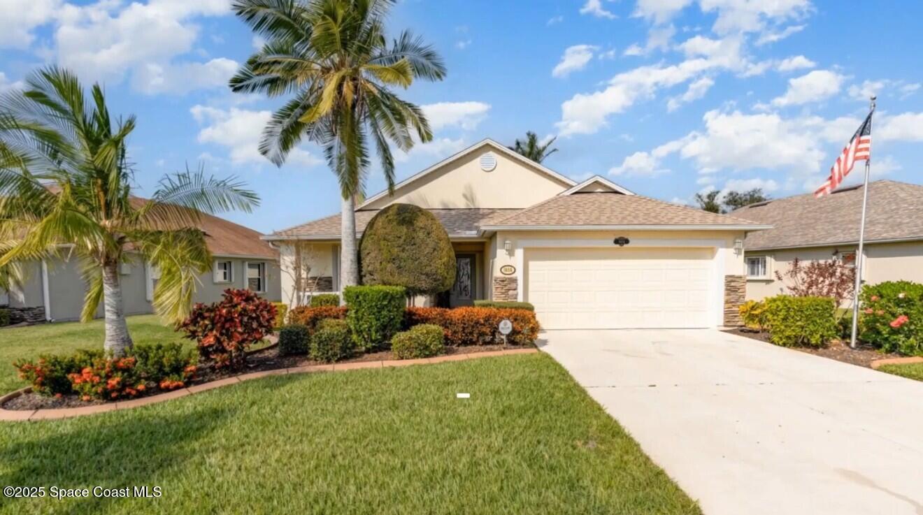 1664 Boca Rio Drive Melbourne, FL 32940 - Photo 2 of 46 a front view of a house with garden
