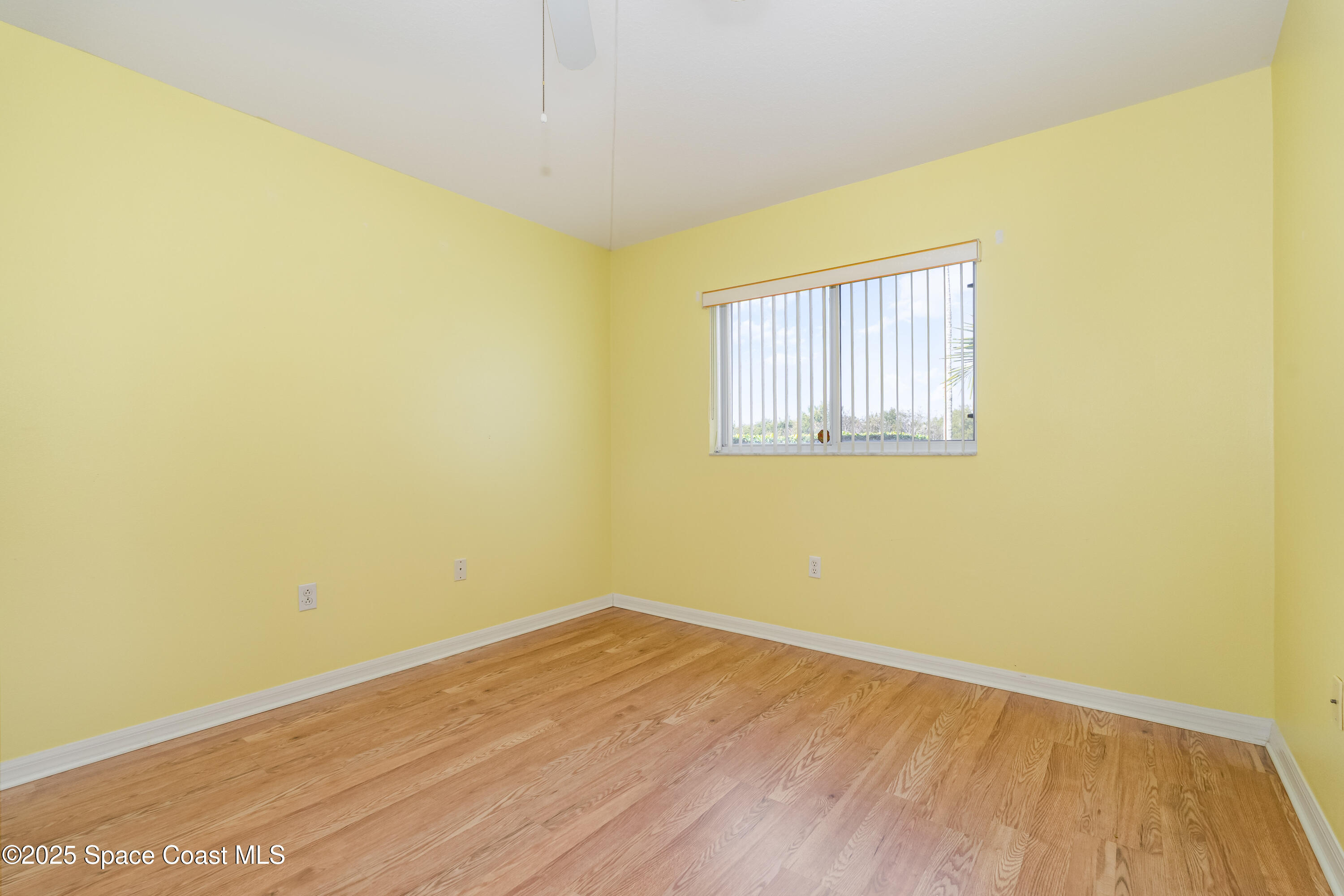 1664 Boca Rio Drive Melbourne, FL 32940 - Photo 21 of 46 an empty room with wooden floor and a window