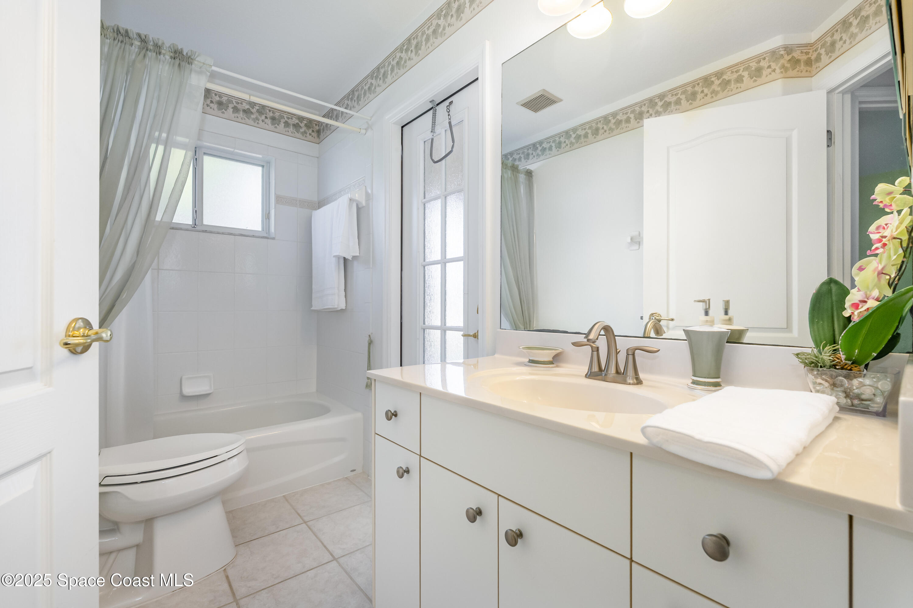 1664 Boca Rio Drive Melbourne, FL 32940 - Photo 22 of 46 a bathroom with a double vanity sink toilet and shower