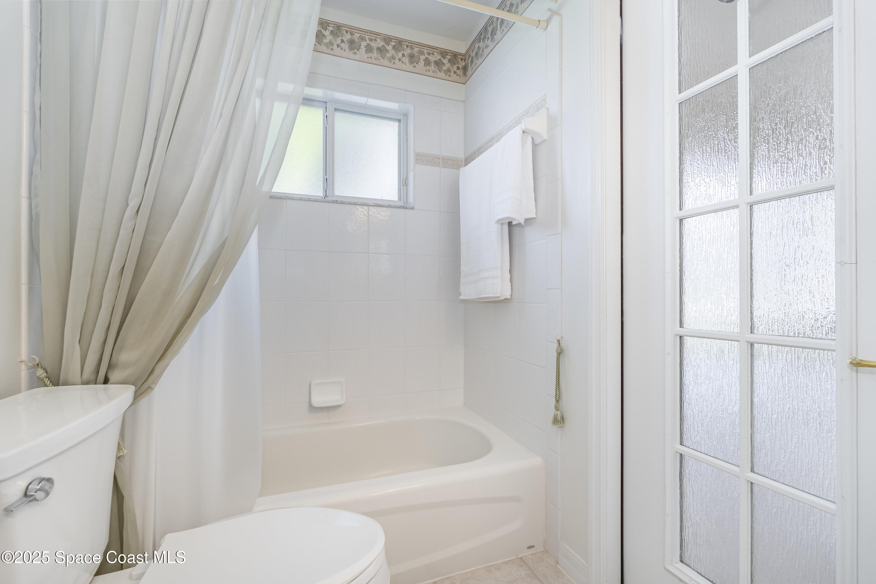 1664 Boca Rio Drive Melbourne, FL 32940 - Photo 23 of 46 a bathroom with a toilet and a bathtub