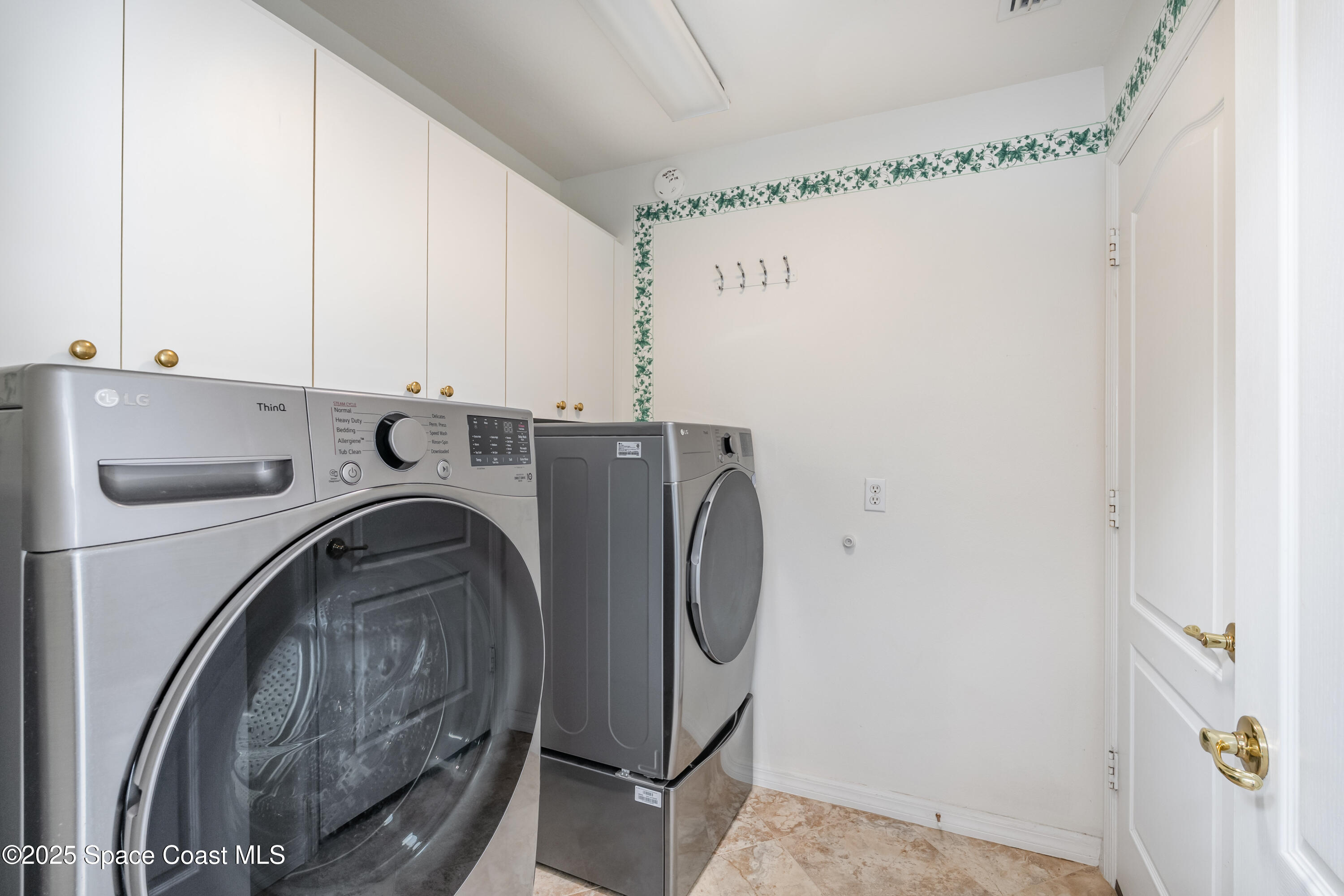 1664 Boca Rio Drive Melbourne, FL 32940 - Photo 25 of 46 a utility room with dryer and washer