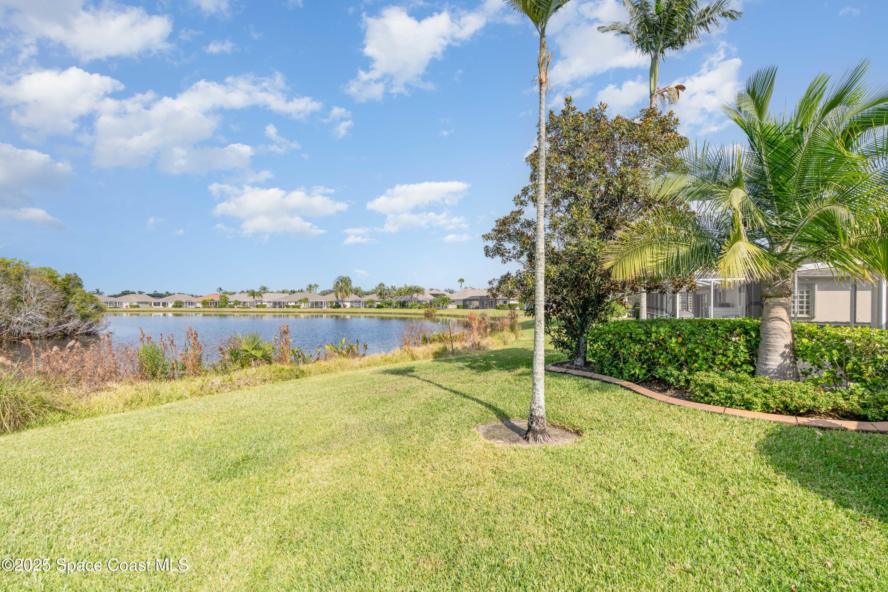 1664 Boca Rio Drive Melbourne, FL 32940 - Photo 28 of 46 a view of a lake with a big yard